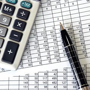 Document with numbers with silver calculator and pen